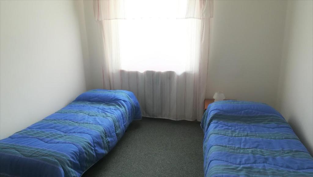 Postel nebo postele na pokoji v ubytování Hotel Tomei