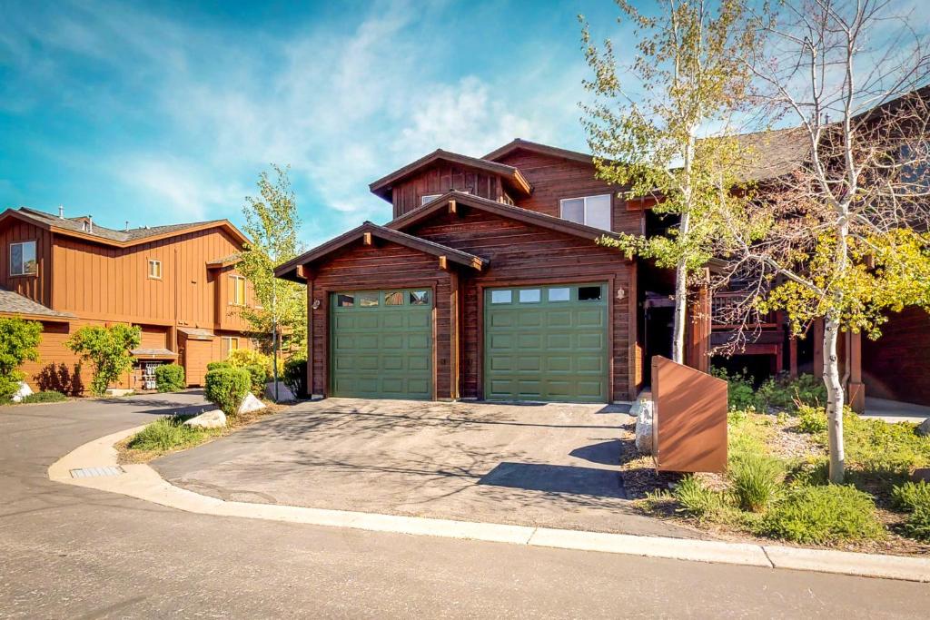 a house with two green garage doors on a street at Boulders Hideout in Truckee
