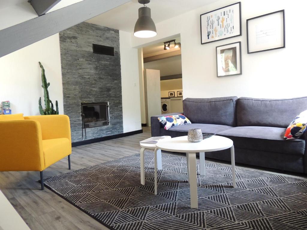 a living room with a couch and a table at L'enclos Sainte-Enimie Gorges du Tarn et Causses in Sainte-Énimie