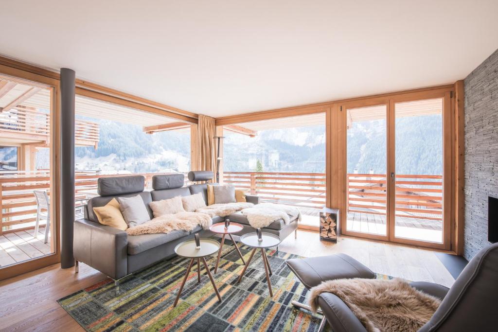 a living room with a couch and a large window at Bernstein in Grindelwald