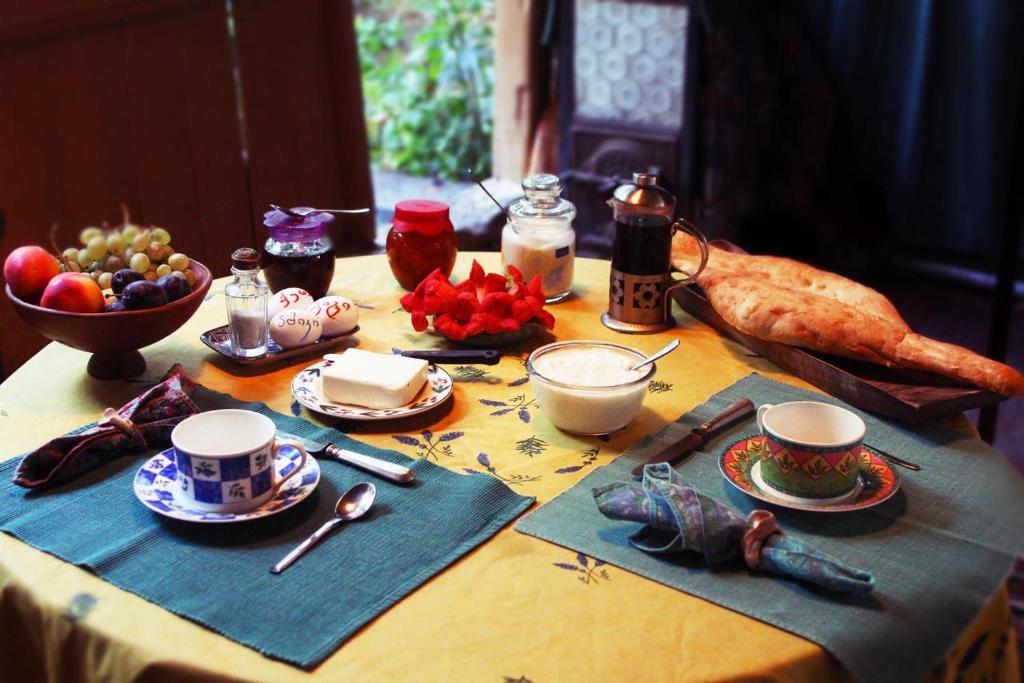 a table with a table cloth with food on it at Guesthouse Nora in Ushguli