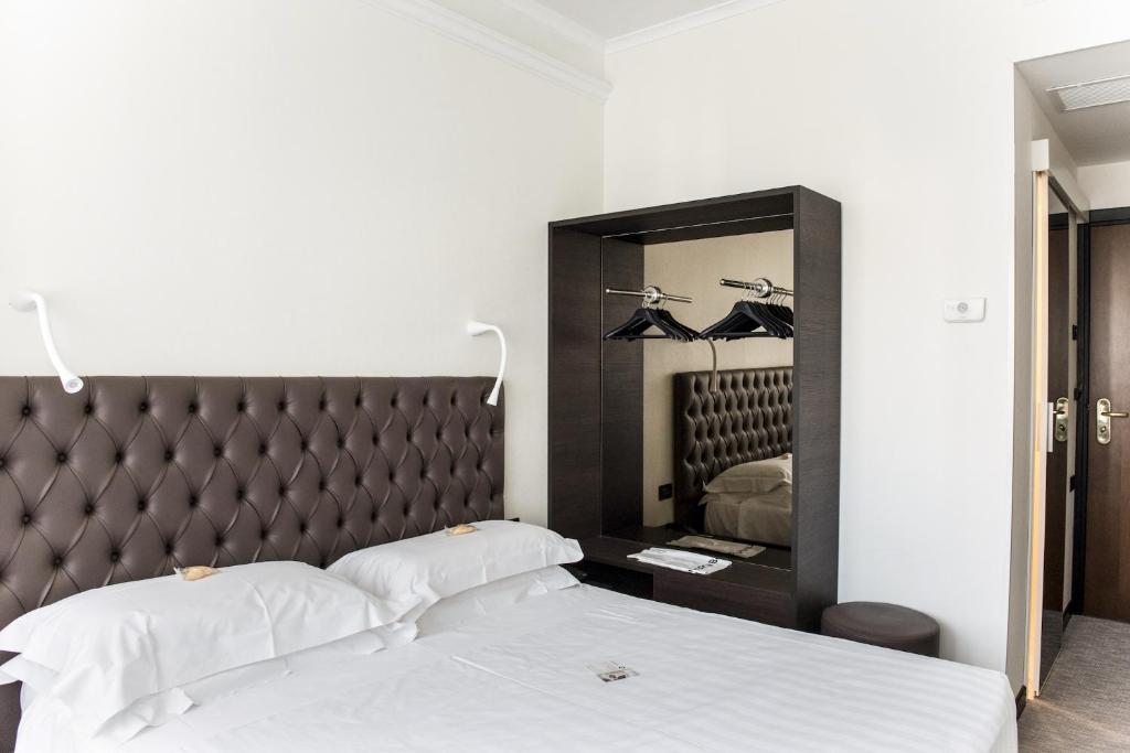 Postel nebo postele na pokoji v ubytování Hotel Plaza