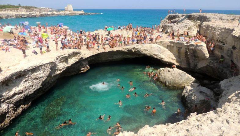 a group of people swimming in a pool at a beach at Casa Meravigli in Cutrofiano