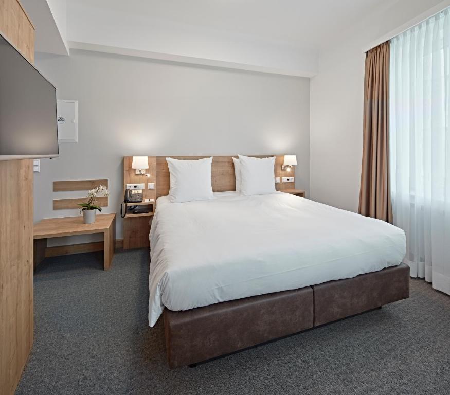 Postel nebo postele na pokoji v ubytování City Hotel