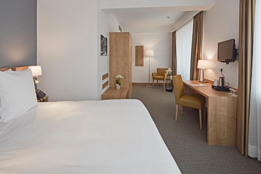 Postel nebo postele na pokoji v ubytování City Hotel