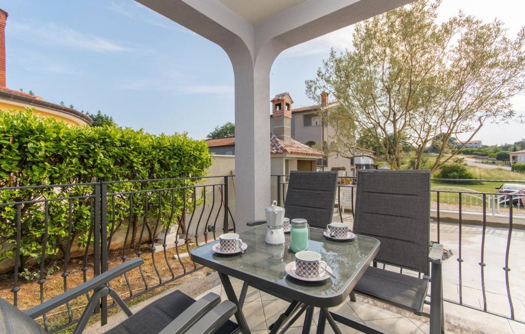 a patio with a table and chairs on a balcony at Silver Holiday House in Poreč