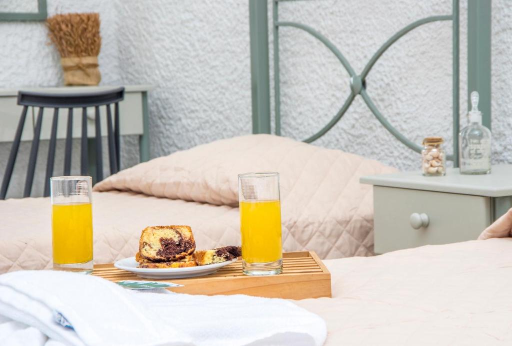 Postel nebo postele na pokoji v ubytování Syros INN