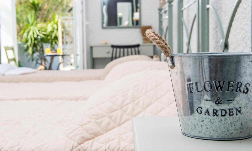 a metal bucket sitting on top of a bed at Syros INN in Galissas