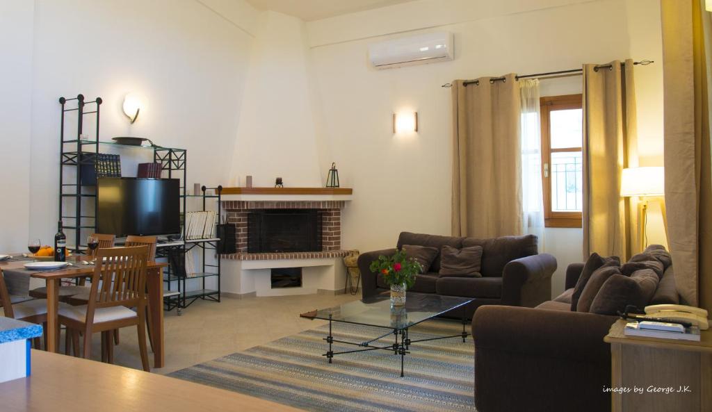 a living room with a couch and a fireplace at Maisonette House Minos in Heraklio