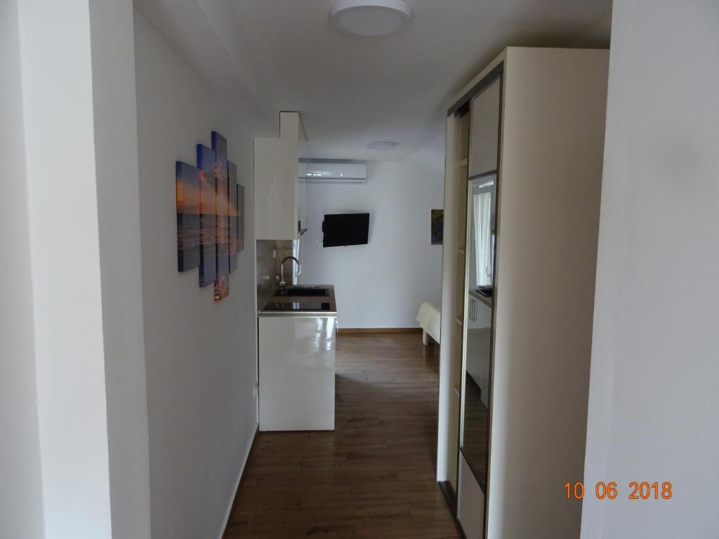 a room with a kitchen and a hallway at Apartments Boss in Budva