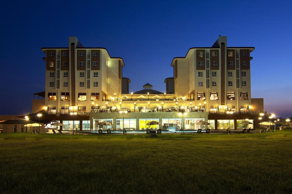 a large building with lights in a field at night at Sandikli Thermal Park Hotel in Sandıklı