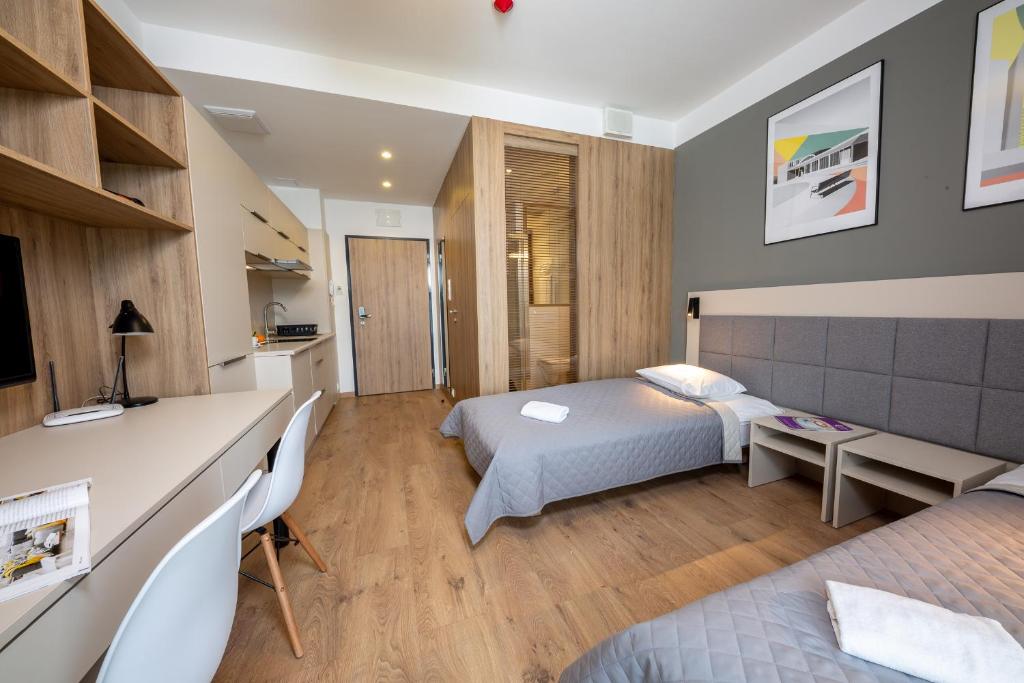 Posteľ alebo postele v izbe v ubytovaní Apartments "Wolska Residence"