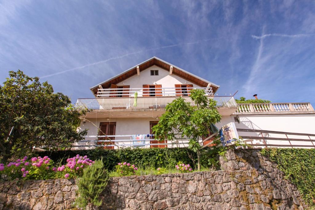 a house on top of a stone wall at Apartments Fisherman in Molunat