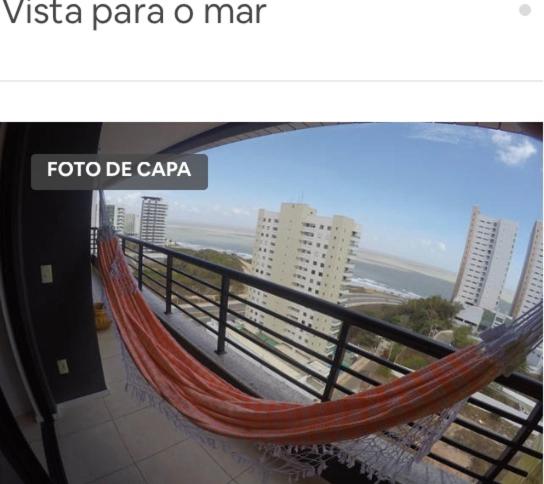 a hammock on a balcony with a view of the ocean at Ap Vista Mar Climatizado in São Luís