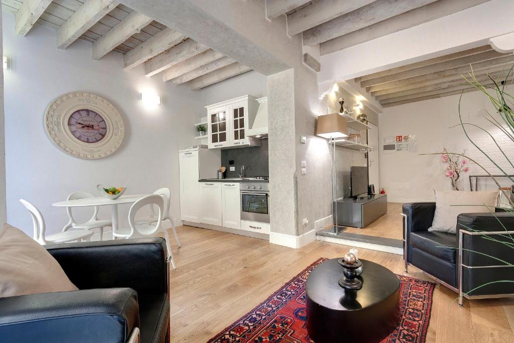 a living room with a couch and a table at De Rustici Apartment in Florence