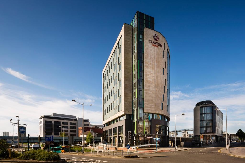a tall building with a clock on the top of it at Clayton Hotel Cardiff in Cardiff
