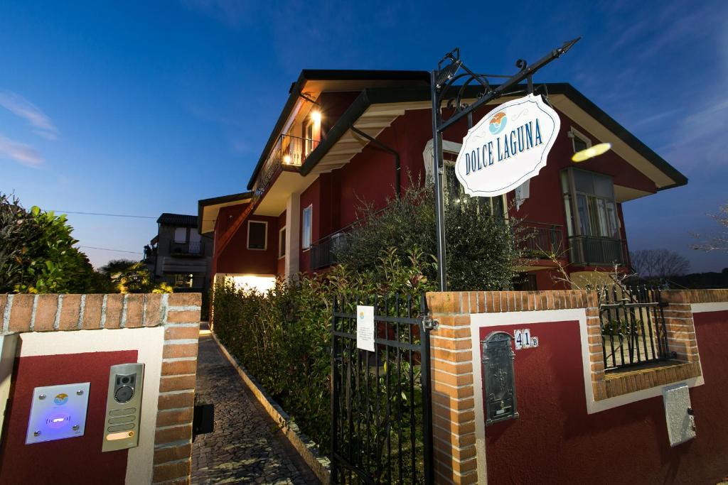 a house with a sign in front of it at Guest House Dolce Laguna in Tessera