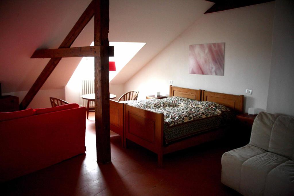 a bedroom with a bed and a table and a chair at Punta Del Corno Agriturismo in San Felice del Benaco