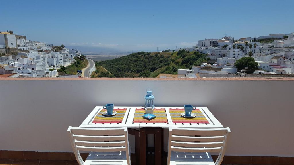 a table and chairs with a view of a city at Holiday home La Atalaya de Vejer in Vejer de la Frontera
