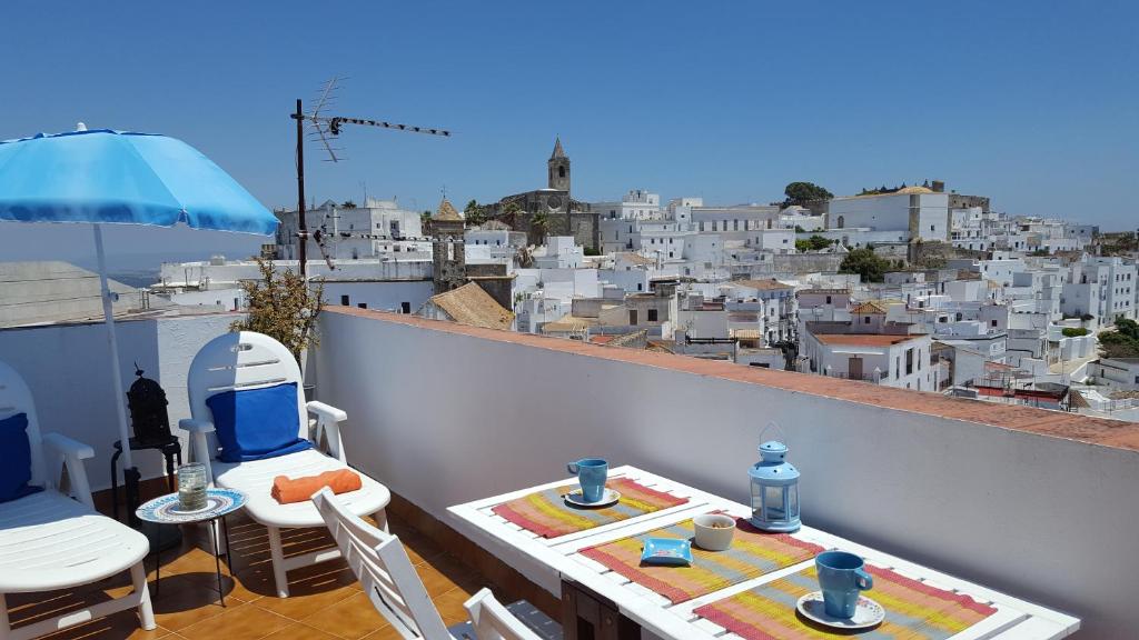 a balcony with a table and chairs and a view of a city at Holiday home La Atalaya de Vejer in Vejer de la Frontera