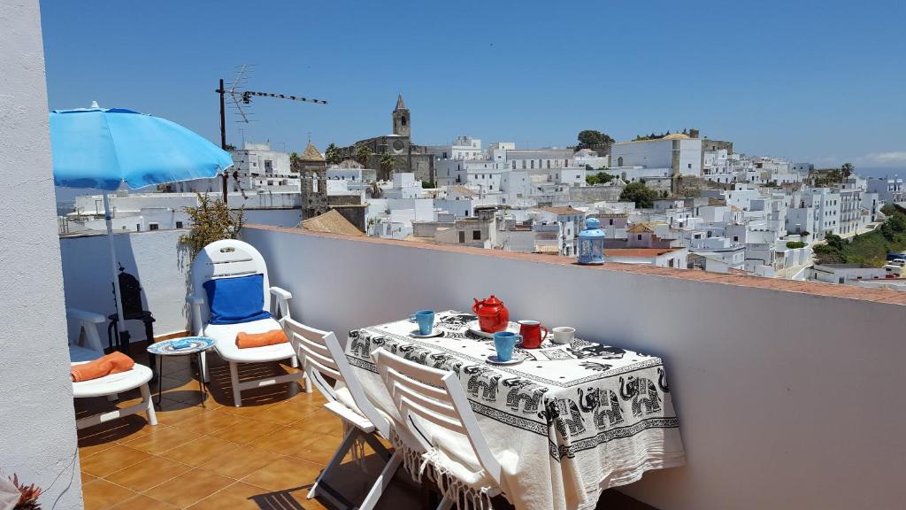 a table on a balcony with a view of a city at Holiday home La Atalaya de Vejer in Vejer de la Frontera