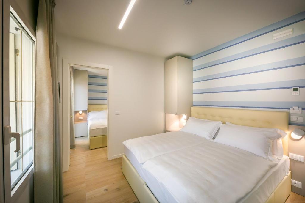Postel nebo postele na pokoji v ubytování Hotel Le Lampare