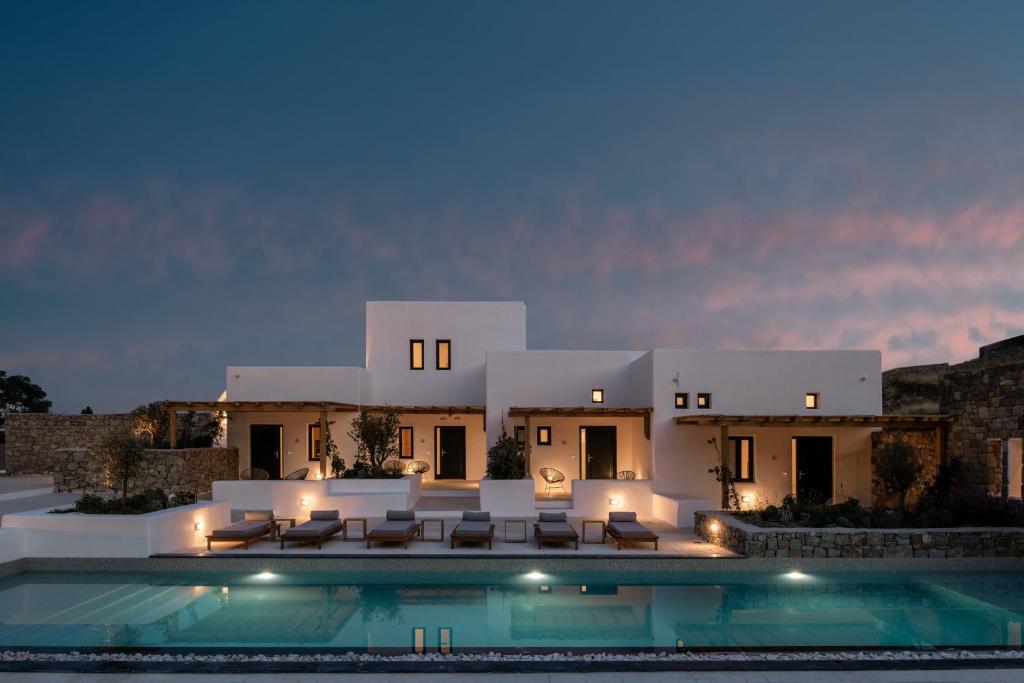 a villa with a swimming pool at night at Mykonos Drops in Platis Gialos