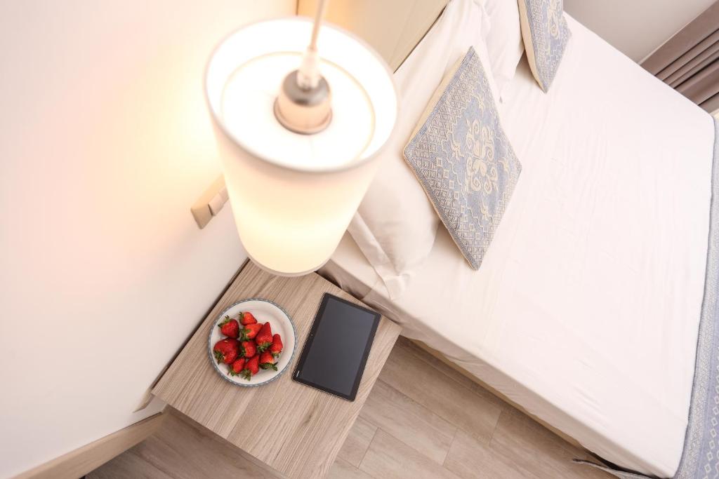 Łóżko lub łóżka w pokoju w obiekcie Alma di Alghero Apartments