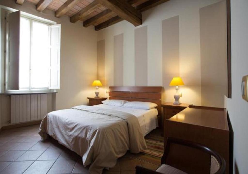 מיטה או מיטות בחדר ב-Il Cortiletto