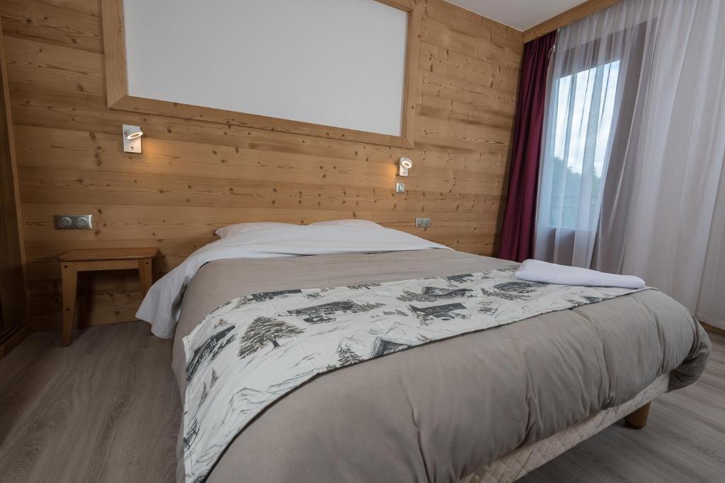 Postel nebo postele na pokoji v ubytování Hôtel Flor'Alpes