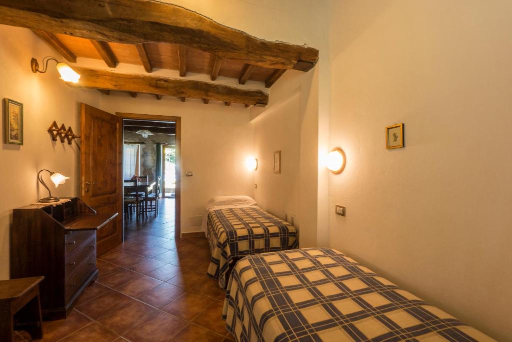 Postel nebo postele na pokoji v ubytování Agriturismo Monte Acuto