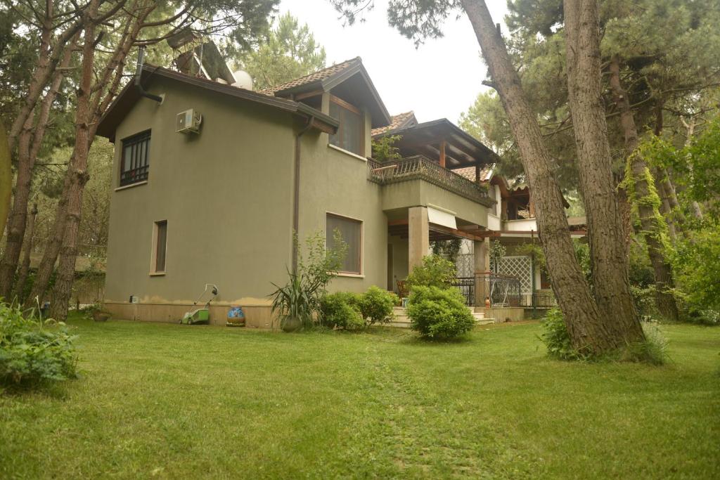 una casa en un patio con un árbol y césped en Villa Miro, en Golem
