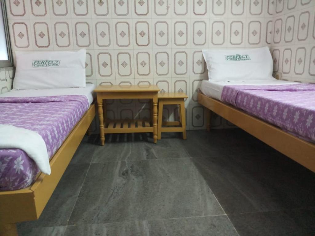 Postel nebo postele na pokoji v ubytování Perfect Guest House