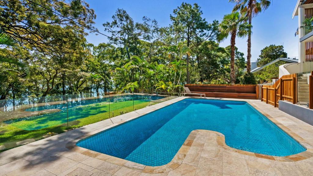 a swimming pool in the backyard of a house at Park Cove Apartments in Noosa Heads