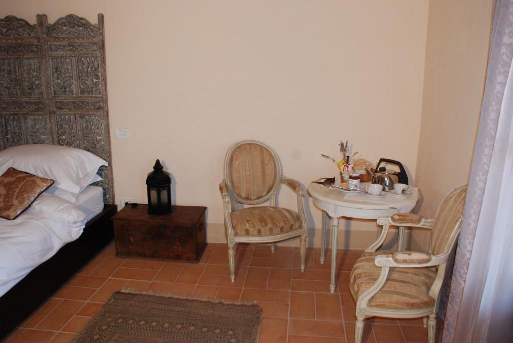 Postel nebo postele na pokoji v ubytování Hotel Podere Conti