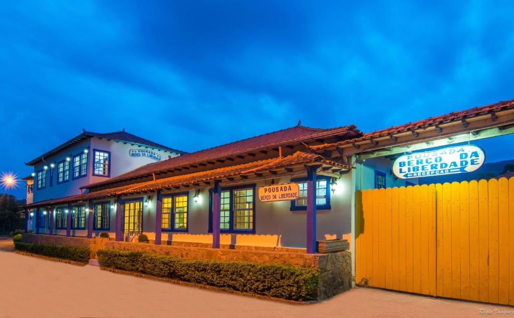 a building with a yellow fence in front of it at Pousada Berço da Liberdade in Tiradentes