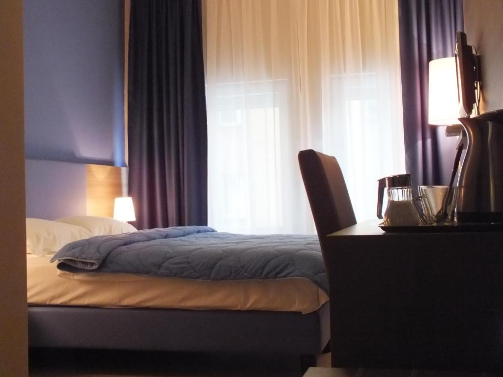 Postel nebo postele na pokoji v ubytování Garni Hotel Zenit