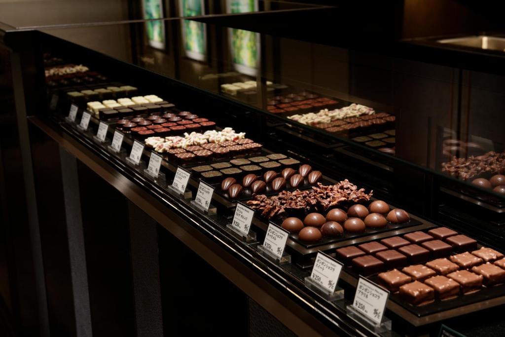 a display case filled with lots of different types of chocolate at Grand Prince Hotel Shin Takanawa in Tokyo