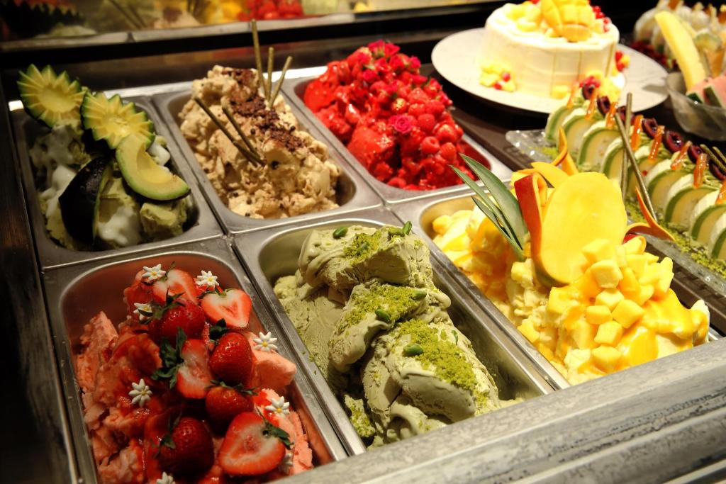 a buffet of different types of food in trays at Grand Prince Hotel Shin Takanawa in Tokyo