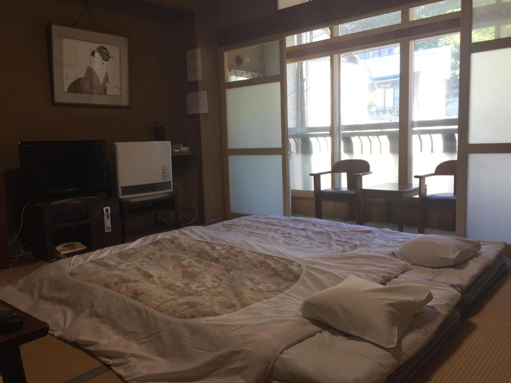 Cama o camas de una habitación en Daymaruya Ryokan