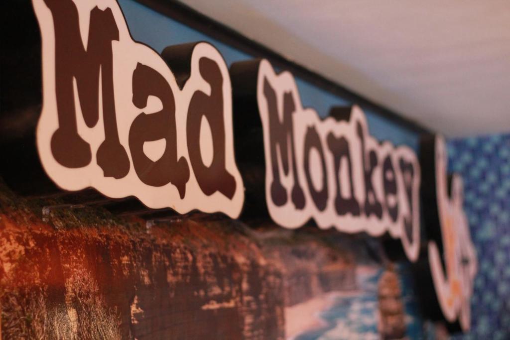 a row of signs on a wall with the words dead nobody at Mad Monkey Kings Cross in Sydney