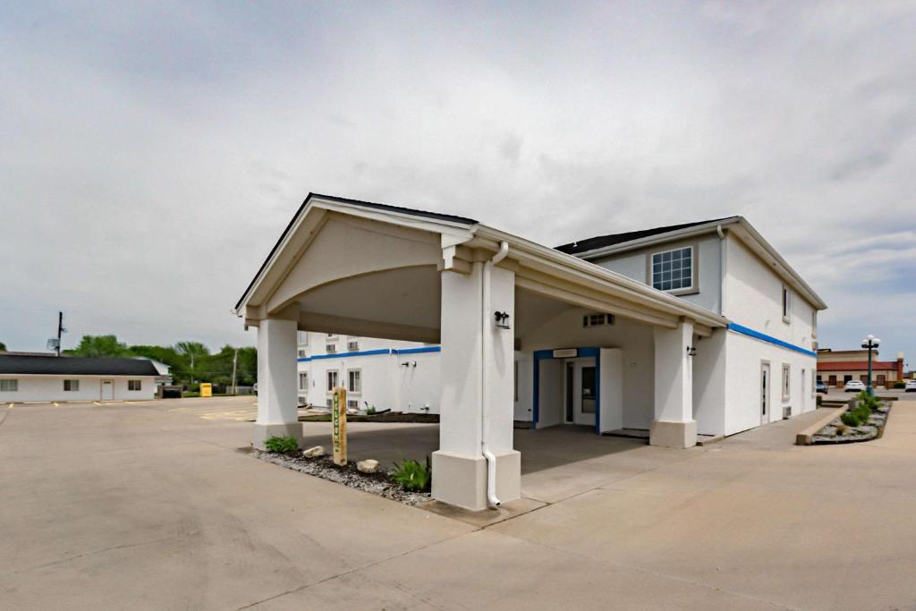 a large white building with a large garage at Motel 6-Augusta, KS in Augusta