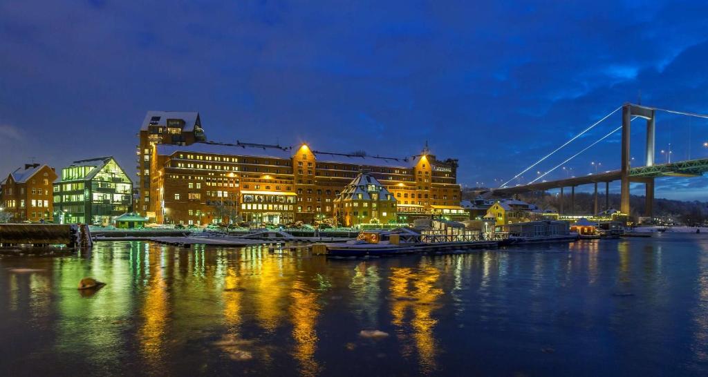 a harbor with boats and a bridge at night at Quality Hotel Waterfront in Gothenburg