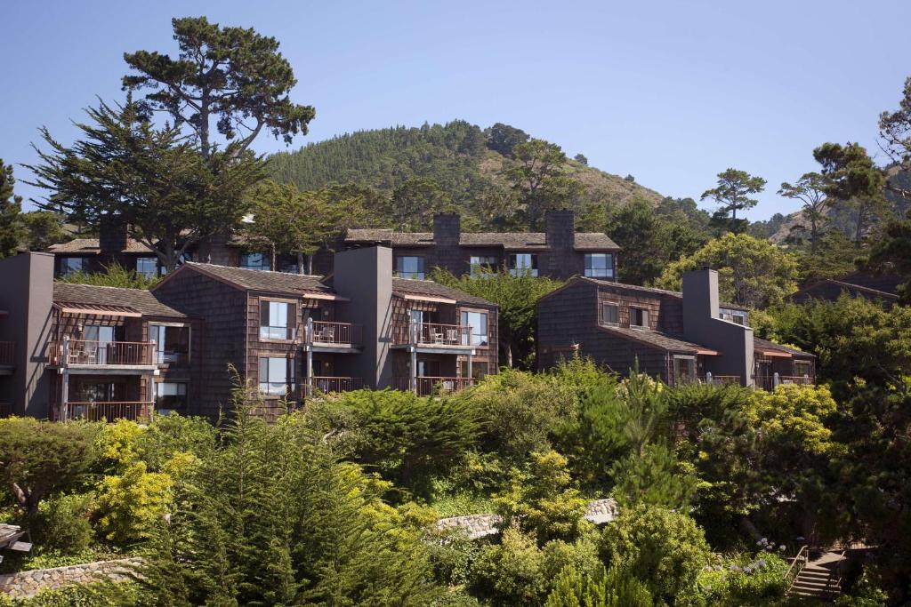 a row of houses on a hill with trees at Hyatt Vacation Club at Highlands Inn in Carmel