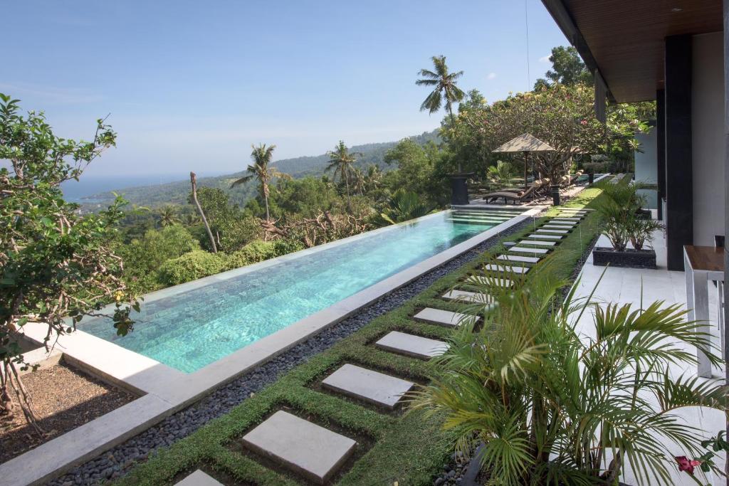an infinity pool with a view at a villa at The Puncak Lombok in Senggigi