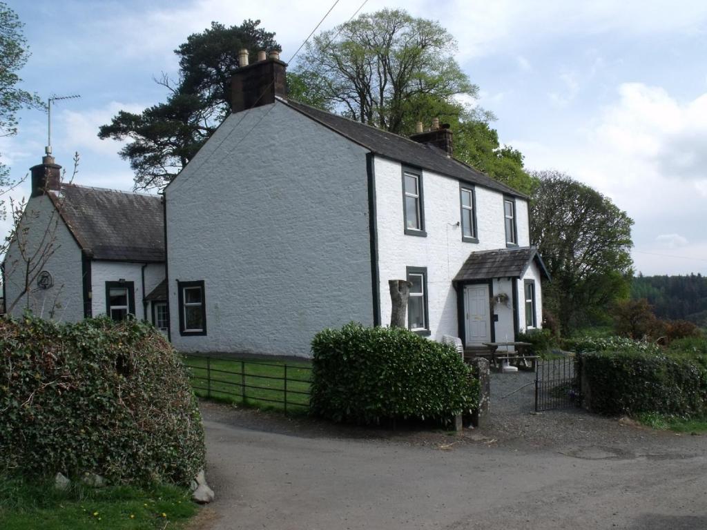 a white house with a black roof at Boreland Farm in Dunscore