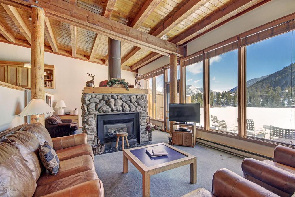 a living room with a couch and a fireplace at 2035 Homestead Condo in Keystone