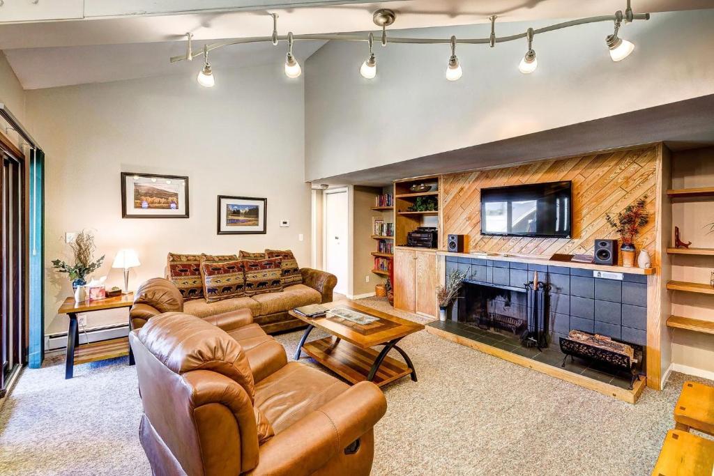 a living room with couches and a fireplace at 1088 Wild Irishman Condo in Keystone