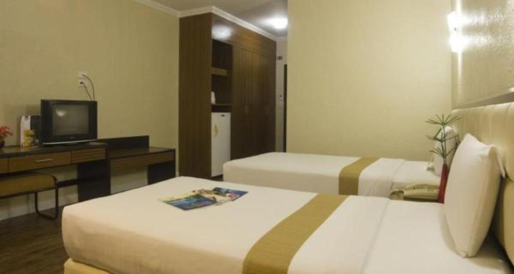 Postel nebo postele na pokoji v ubytování Rothman Hotel