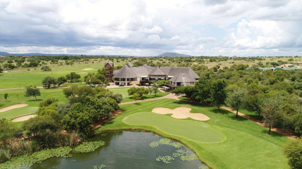 an aerial view of a golf course with a house at Zebula Golf Estate & Spa Executive Holiday Homes in Mabula